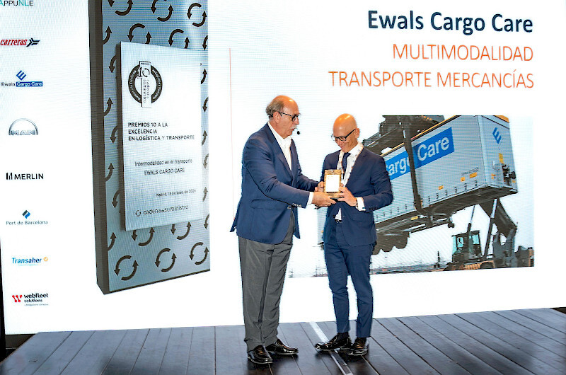men standing with award on stage